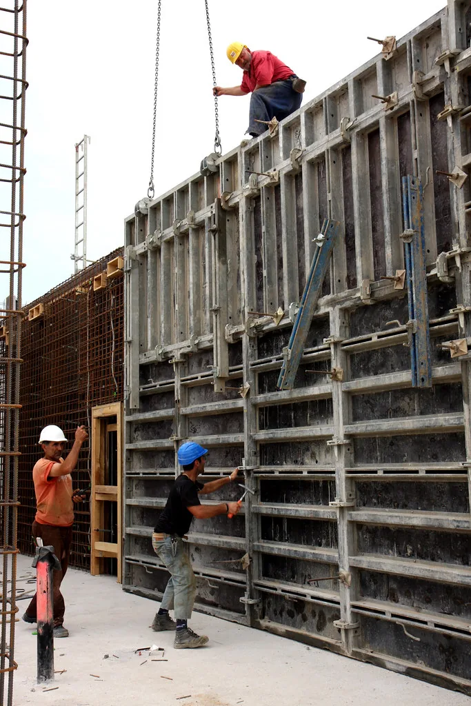 Construction workers on scaffolding at a building exterior
