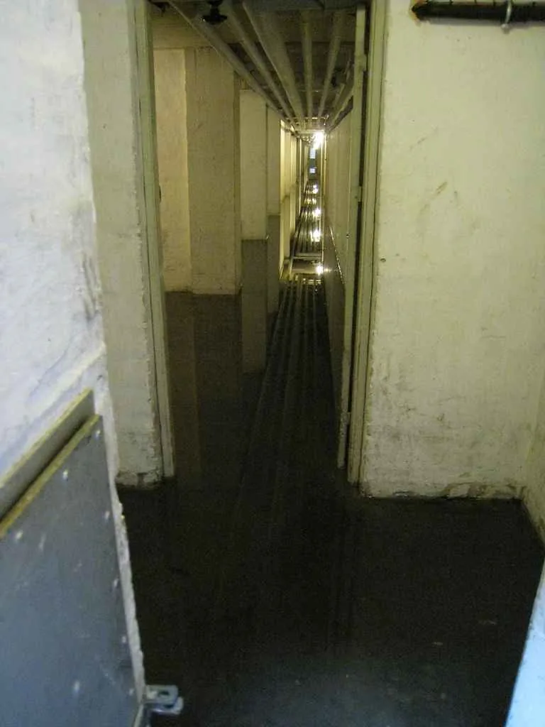 Dark interior hallway with standing floodwater