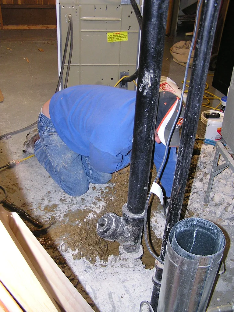 Plumber working on pipes