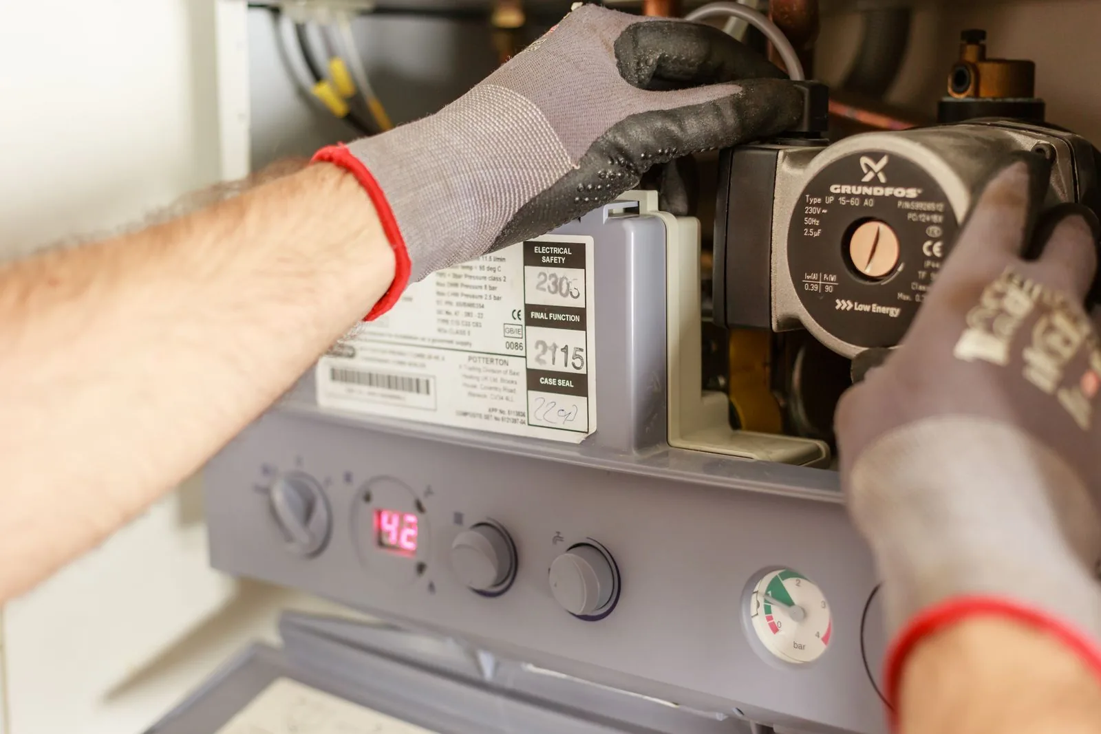 Technician's hands adjusting precision instrumentation on equipment