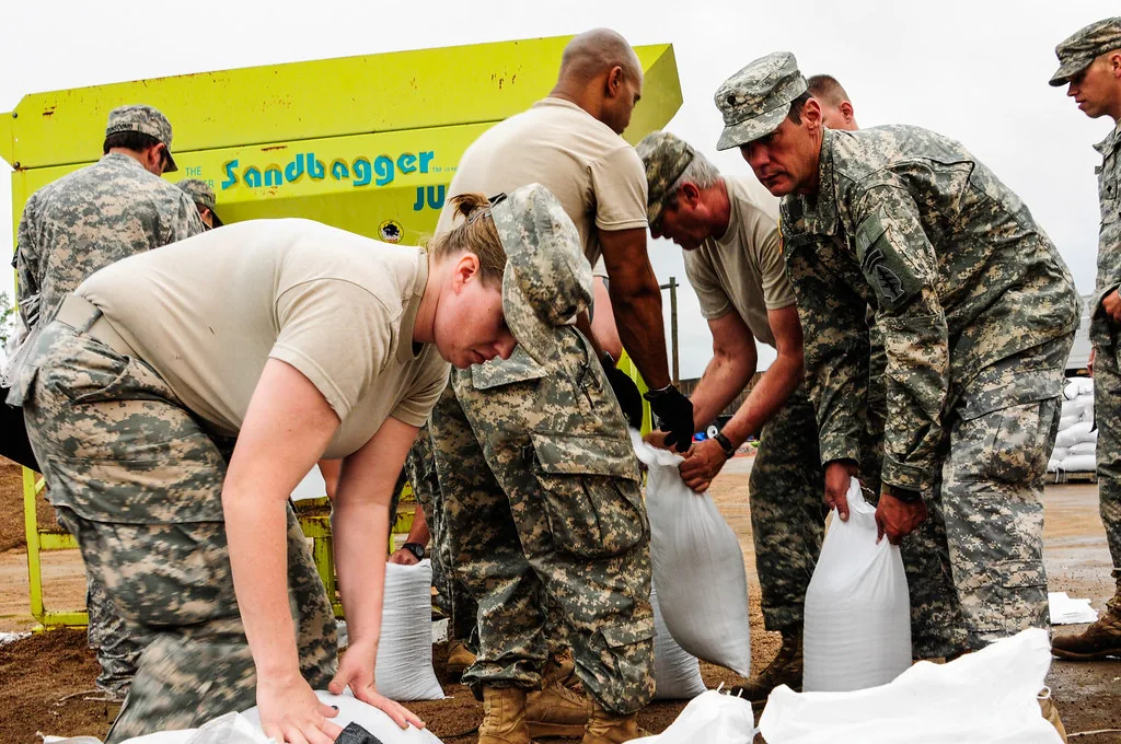 Volunteers filling sandbags for flood defense