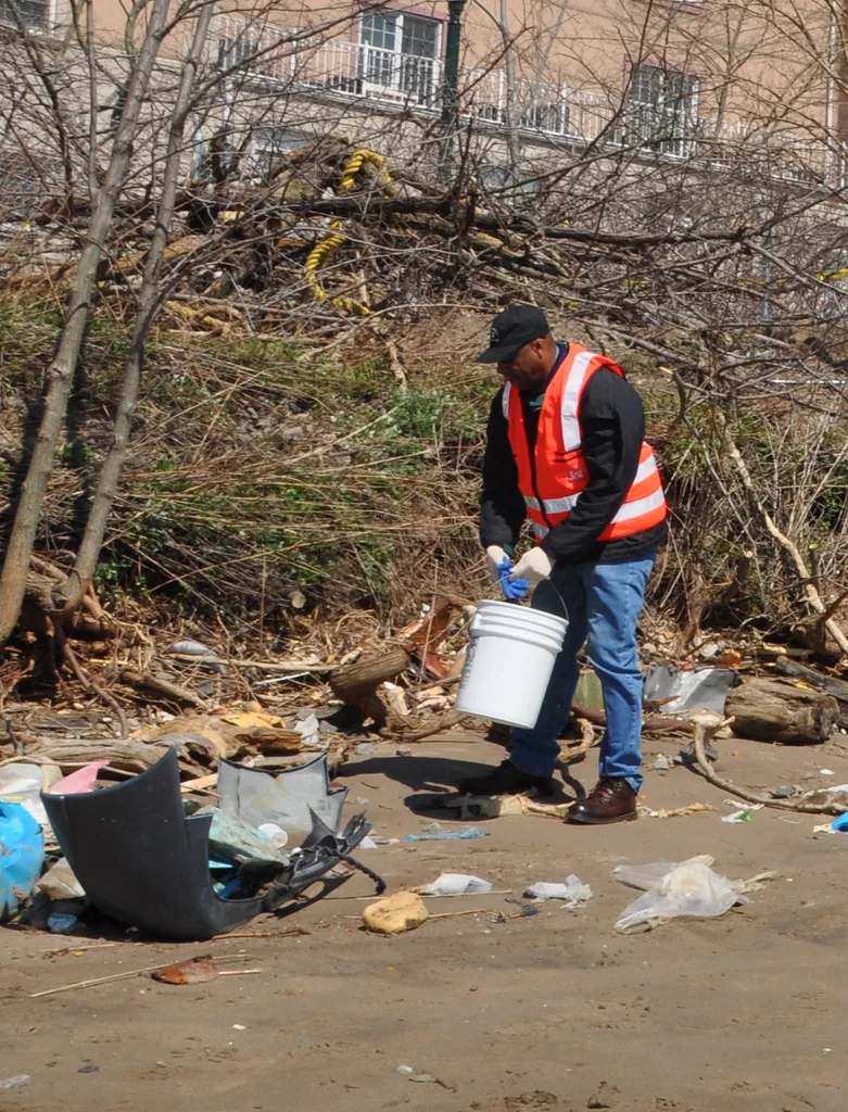 Worker cleaning mud from a flooded area